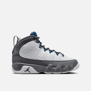 Gray and white sneaker with blue accents on a white background